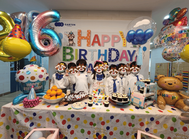Korean kindergarten students posting for a picture for a birthday party at i-garten institute