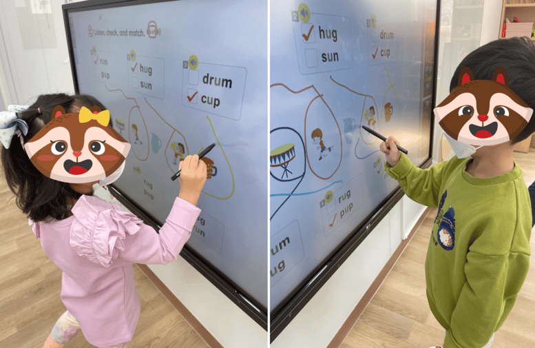 kindergarten Korean students writing on a smart board at the i-garten institute