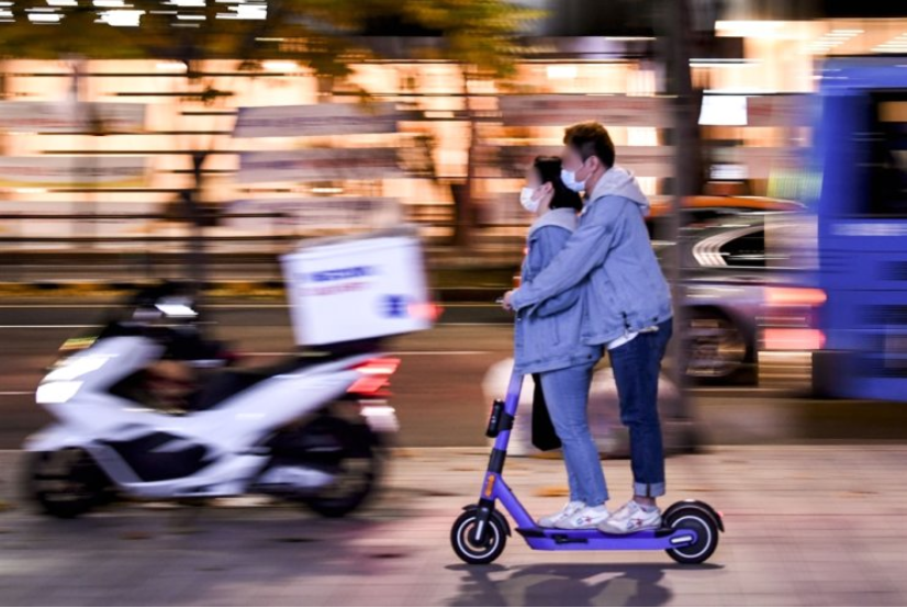 Couple riding an e-scooter in Korea