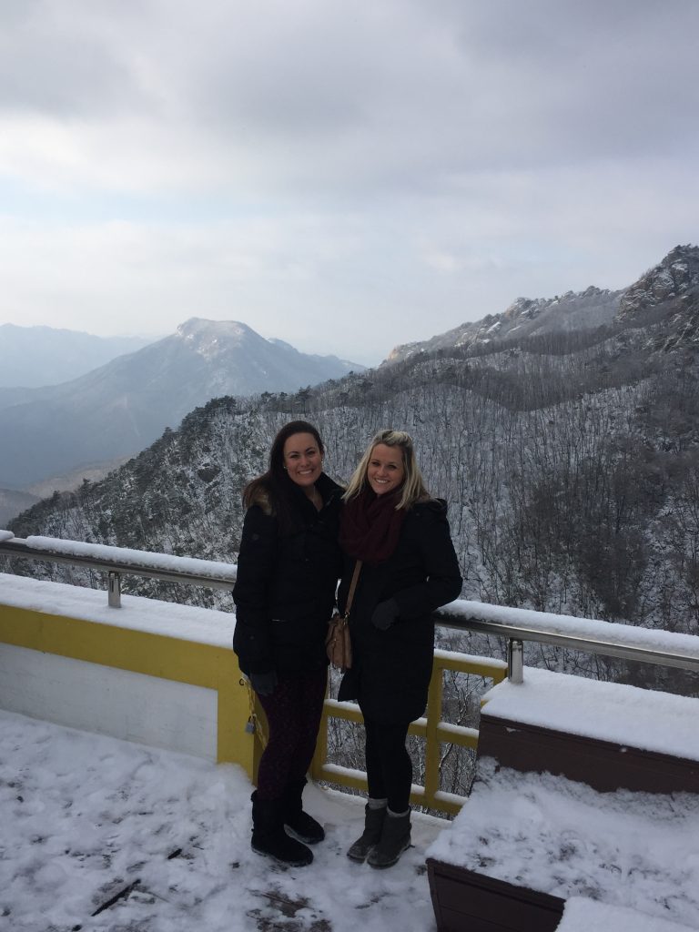 Two native English language teachers posing on a mountain in Korea
