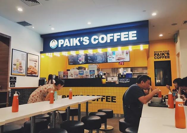 Inside a Paik's Coffee in Korea with bright yellow colors unique to its own Korean cafe culture