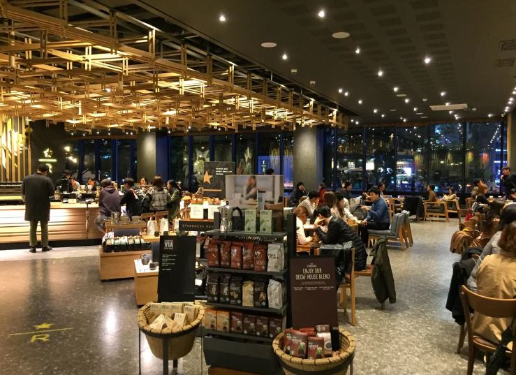 Inside of a filled .Starbucks in Korea at night