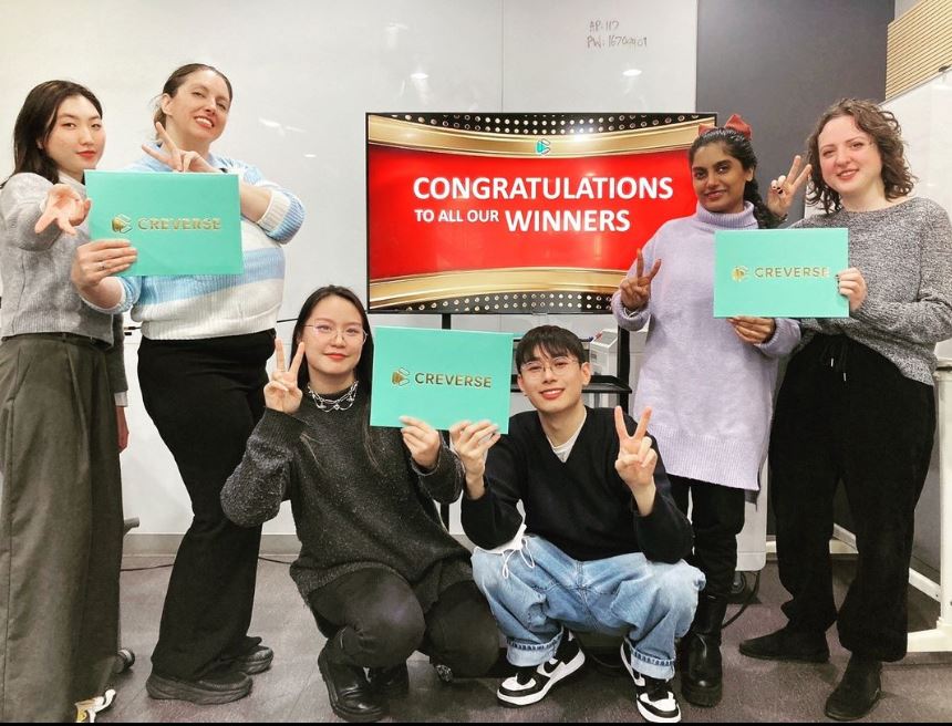 A group of English language teachers posing with awards in South Korea