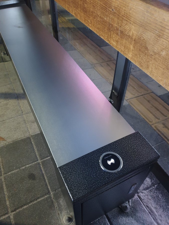 A heated bus stop bench with free wirless charging in Korea