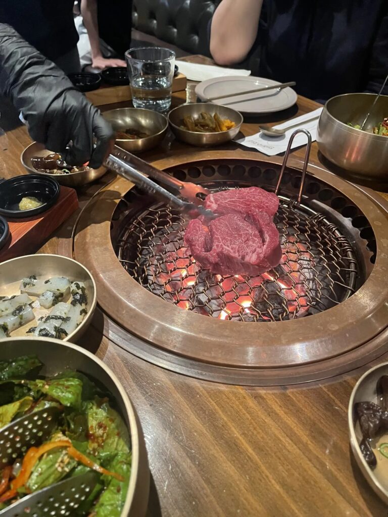 Hanwoo Korean beef being grilled tableside.