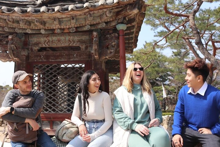 English teachers in Korea laughing in front of a pagoda