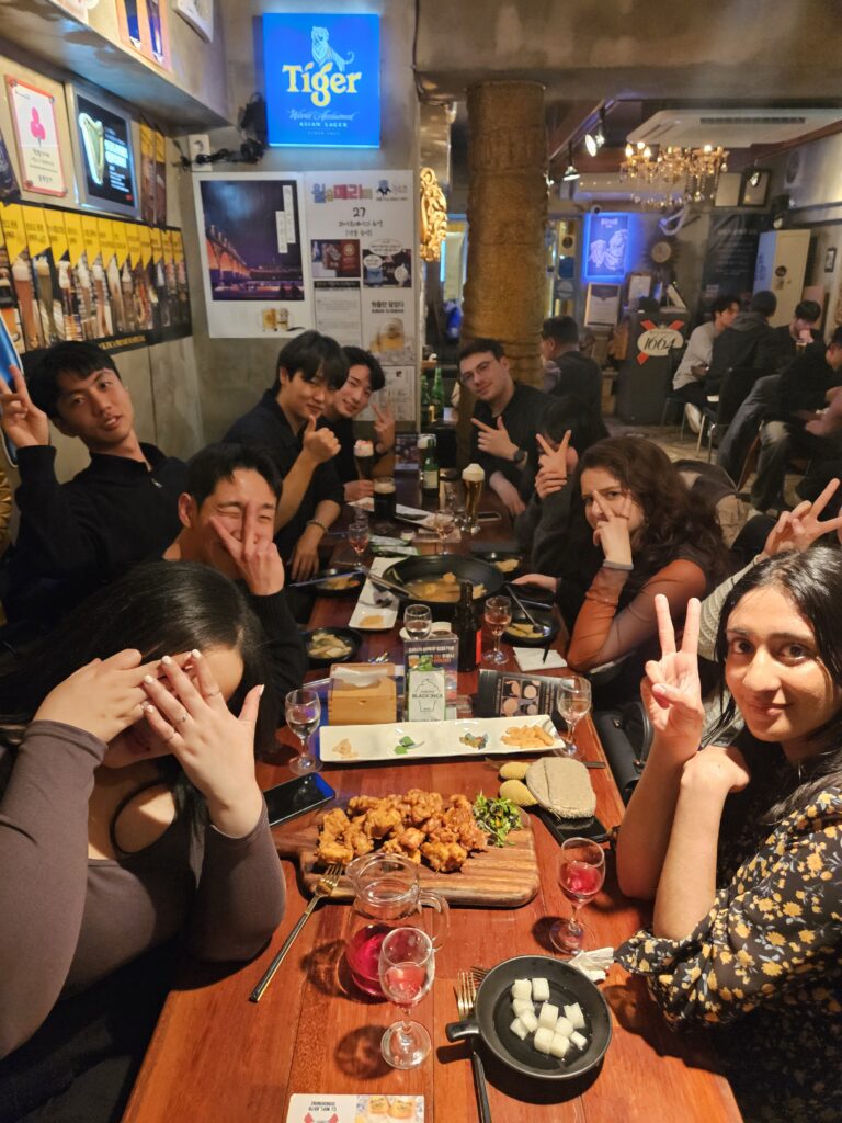 A group of English teachers and Korean staff at a dinner after classes are over.