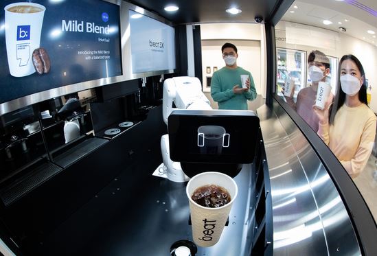 People waiting for coffee to be made at a robot coffee shop