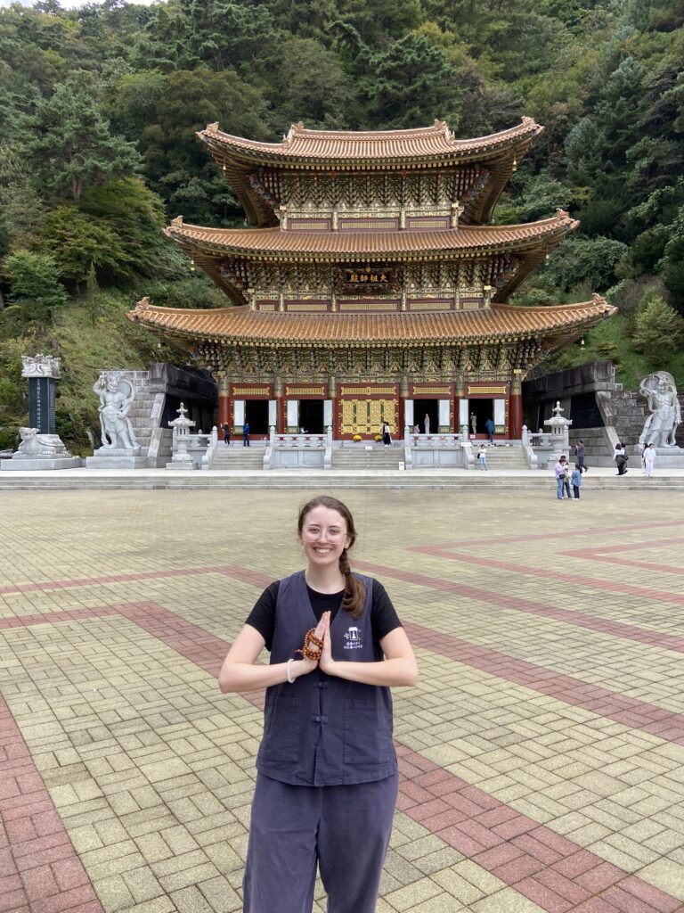 A Native English language teacher posing in front of a buddhist temple in South Korea